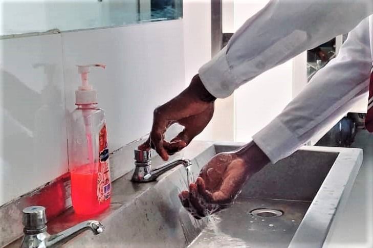 hands in sink